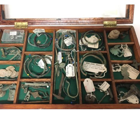A case containing very interesting Antiquities Roman and Greek bangles and other metal and bronze implements in a display cas