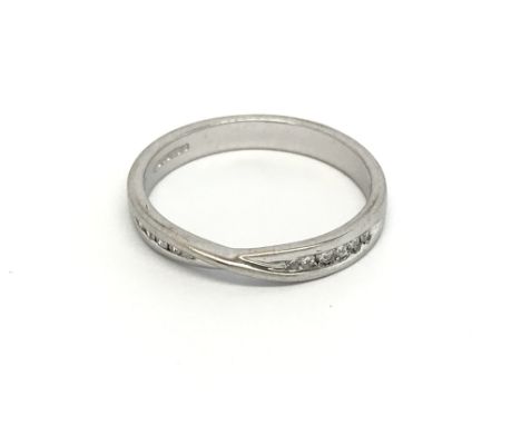 An 18carat white gold ring set with a row of brilliant cut diamonds. ring size N