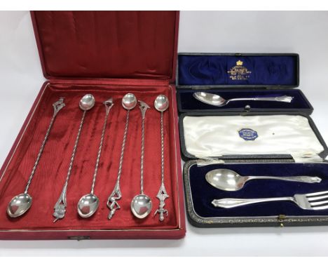 A cased set of 6 long silver spoons plus cased hallmarked silver spoon and a cased hallmarked silver fork and spoon set.