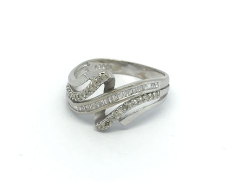 A 9ct white gold and baguette and round cut diamond ring, (R), 31.g, 1 stone missing.