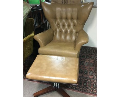 A Vintage G-Plan large revolving wing arm chair with button back and a conforming foot stool with Chrome and rosewood support