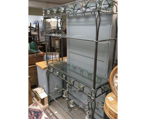 A modern wrought iron and glass open display shelf with three glass shelves