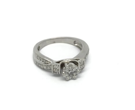 A well detailed modern design 18 carat white gold ring set with a pattern of diamonds. ring size J.