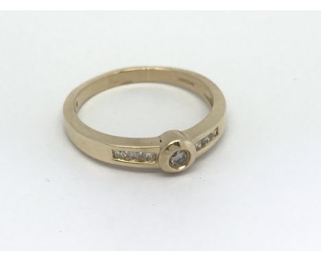 A 9ct gold diamond solitaire ring with diamond set shoulders, approx .25ct, 3.4g.