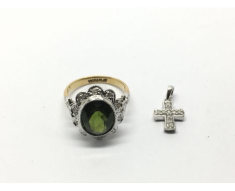 An 18ct gold and platinum ring set with a green tourmaline and small diamonds together with a small cross pendant, approx 5.4