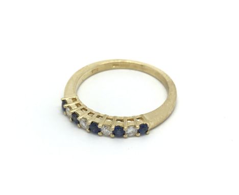 An 18carat gold ring set with alternating diamonds and Ceylon Sapphires ring size N.