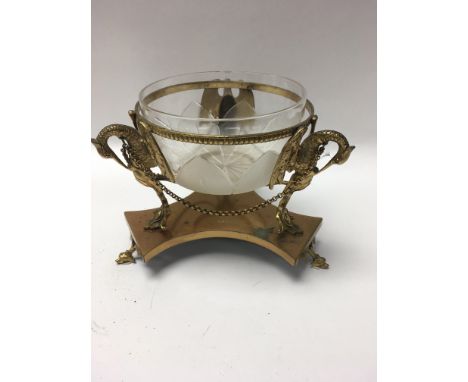 A glass sugar bowl inset into a gilt Classical stand together with a pair of gilt wine coasters and a small Art Nouveau mante