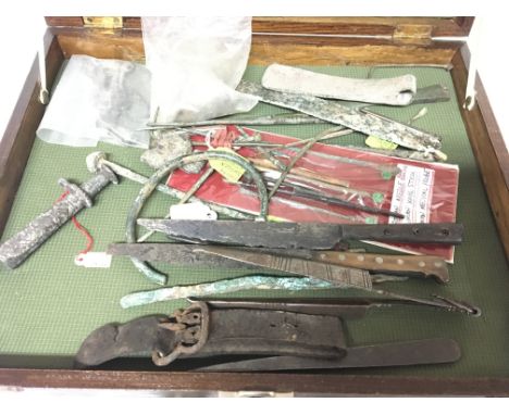 A case containing Antiquities metal doctor finds including Roman bronze pins an unusual bronze metal 7th century idol stand a