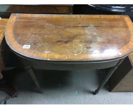 A Georgian mahogany card table the twin d end top above turned legs - NO RESERVE