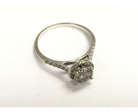 An 18ct white gold (unmarked tested ) illusion set diamond ring. Q.