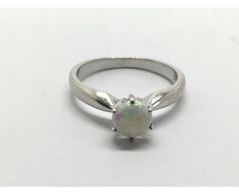 A 14ct white gold ring set with an opal, approx 2.9g and approx size M.