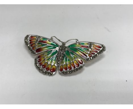 A large silver butterfly brooch inset with marcasite and plique a jour enamel.