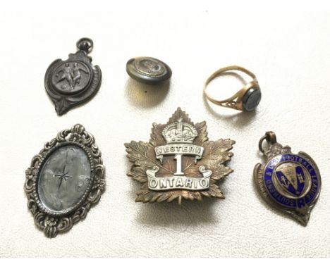 A gold ring, Southend football medal, military badge and other oddments.