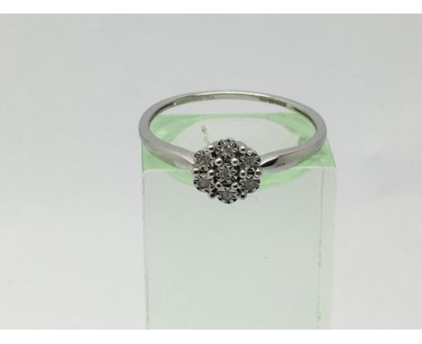 A 9ct white gold seven stone diamond ring, approx 1.2g and approx size O.