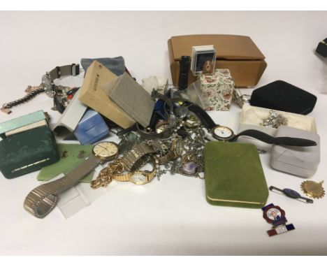 A collection of costume jewellery including a Daily Mail 1937 enamel badge watches brooches and necklaces (a lot)