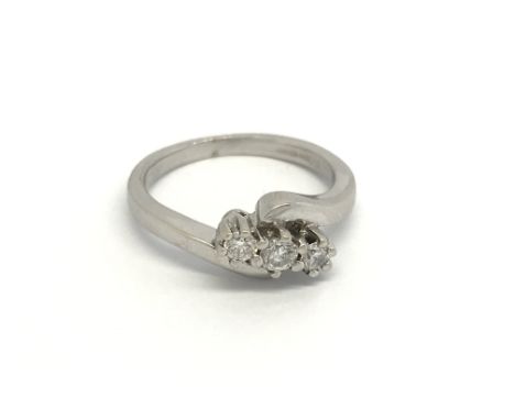 An 18carat gold ring set with three brilliant cut diamonds. Ring size K