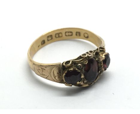 An antique 22ct gold ring inset with garnets, approx 2.8g and approx size L-M.