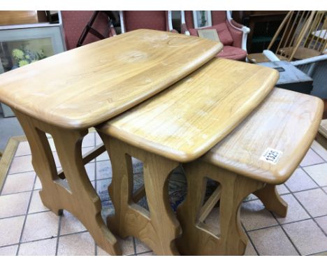 A nest of three light blonde Ercol Elm occasional tables. Some watermarks to the tops otherwise good condition.