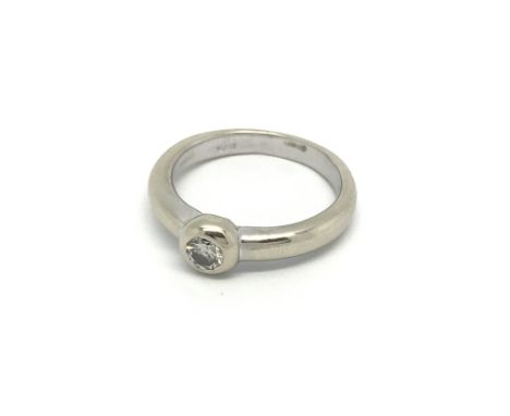 An 18ct white gold and 0.25ct diamond solitaire ring. (M.5), 5.7g.