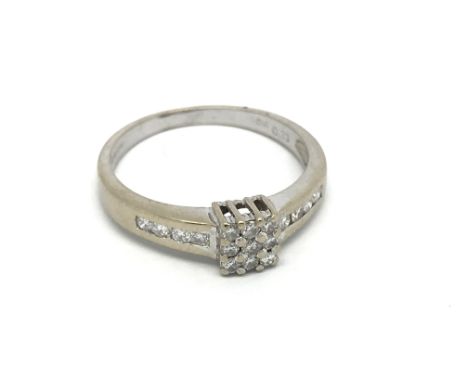 An 18carat gold ring set with a square pattern of diamonds the shank set with further diamonds. ring size O.