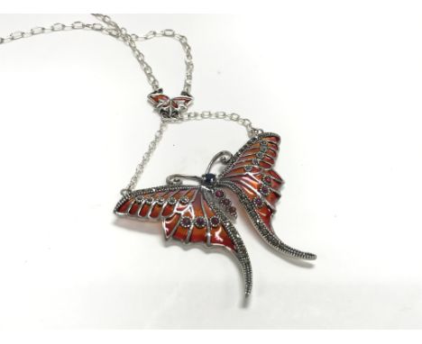 A large silver butterfly necklace set with cabochone rubies, marcasite, and multi coloured pliqu a jour enamel.