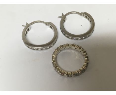 A pair of silver earrings set with CZ stones and a conforming silver eternity ring - NO RESERVE