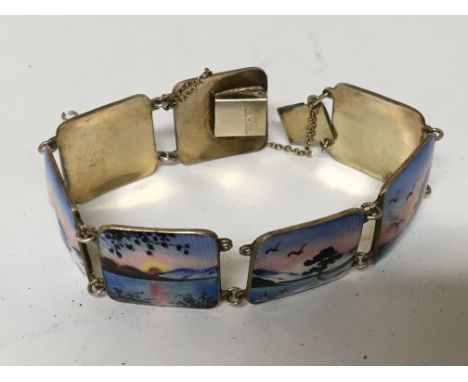 A Norwegian silver and enamel bracelet each section with traditional scenes.