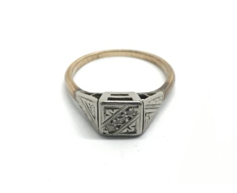 A white and yellow gold ring set a pattern of chip diamonds, approx 2.7g and approx size L.