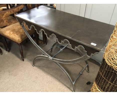 A modern design metal console table with a bronzed metal top and shaped appron.