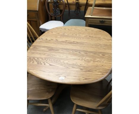 An Ercol light coloured Elm dining table with an extra internal fitted leaf.