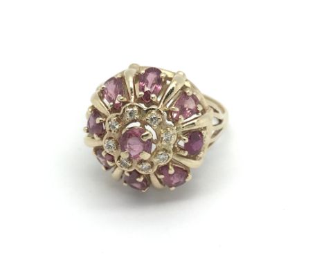 A 14ct gold dress ring set with armadine garnets and diamonds, approx 6.2g and approx size Q-R.