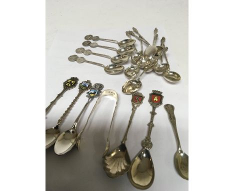 A collection of Chinese white metal tea spoons silver sugar tongs and other enamel decorated spoons.