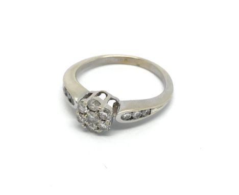 An 18carat gold ring set with a pattern of brilliant cut diamonds. Ring size L.