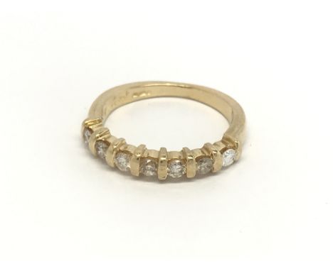 An 18carat gold ring set with a a subdivided row of brilliant cut diamonds ring size K