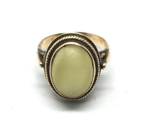 A 14k gold ring set with a polished stone, approx 5.4g and approx size I-J.