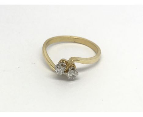 An 18carat gold ring set with a two diamond cross over ring size N