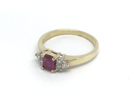 An 18ct gold six stone diamond ring set with a central ruby, approx 1/2ct, approx 3g and approx size O.
