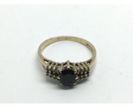 A 9ct gold ring set with a central stone and small diamonds, approx 2.2g and approx size N.