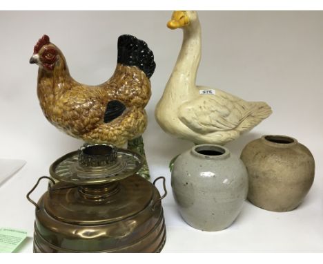 A ceramic model of a chicken life size a plaster figure of a duck two stoneware jars and a brass Ardent Heater (a lot)