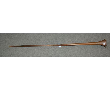 A brass hunting horn, 123 cm long Condition Report: Available upon request