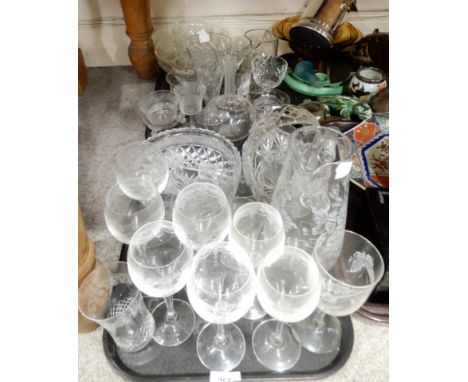 A selection of cut glass and crystal including a frosted glass pitcher with floral decoration, wheel engraved drinking glasse