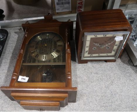 An Art Deco battery operated cased wooden mantle clock and a cased wooden Acctim wall clock Condition Report: Not available f