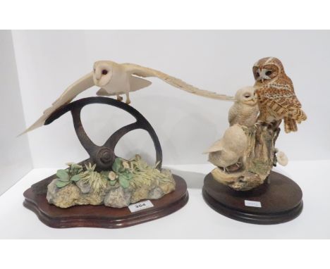 A Border Fine Arts group of a hunting Barn Owl, signed Ayres 704/1250, together with another of a Tawney owl and owlets Condi