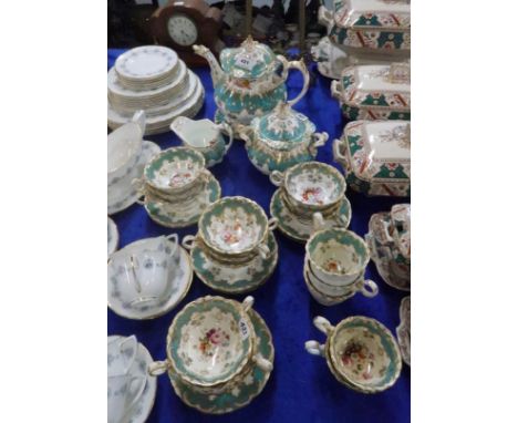 A Victorian turquoise and white ground teaset each painted with a bouquet of flowers comprising teapot, milk jug, sugar bowl,