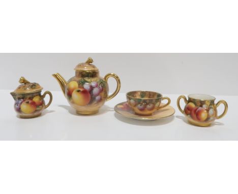 A Royal Worcester miniature fruit painted teaset including a cup and saucer, teapot, milk jug and sugar bowl signed W. Robert