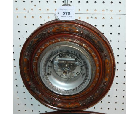 An oak cased circular barometer, 24cm wide Condition Report: Available upon request