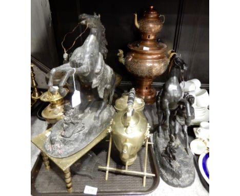 A lot comprising a quantity of brass candlesticks, a pair of spelter marley horses, a brass spirit kettle, brass oil lamp bas