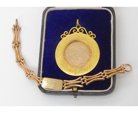 A 9ct gold Dux medal, and a 9ct gold identity tag gate bracelet weight combined 24.1gms Condition Report: Available upon requ