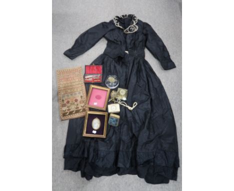 A Victorian Sampler by Agnes Carrick, a late 19th/early 20th century silk mourning dress with embroidered collar, retailed by
