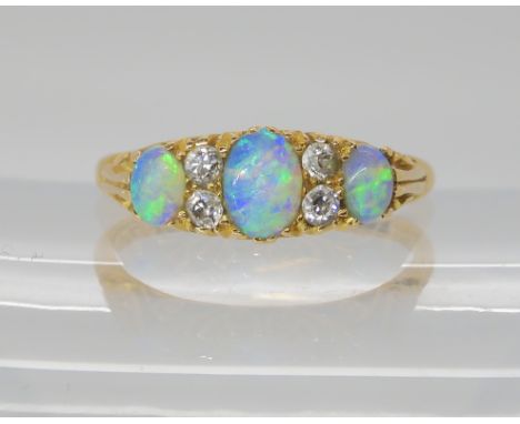 An 18ct gold opal and diamond ring, set with estimated approx 0.15cts of old cut diamonds, Chest hallmarks for 1908, finger s